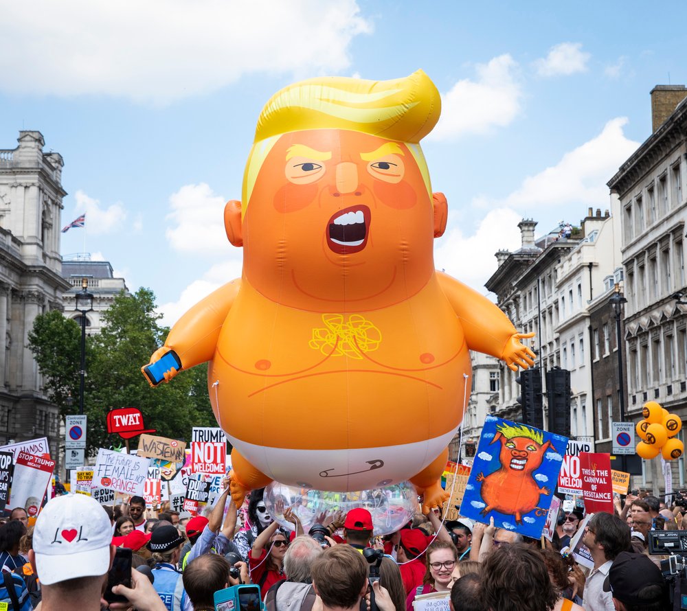 9a28bb205shutterstock_9760885q-jpg.jpeg Thousands of protesters march alongside the 'Trump baby' balloon in central London during President Trump's visit to the U.K. on July 13, 2018. (Rob Pinney/LNP/Shutterstock)
