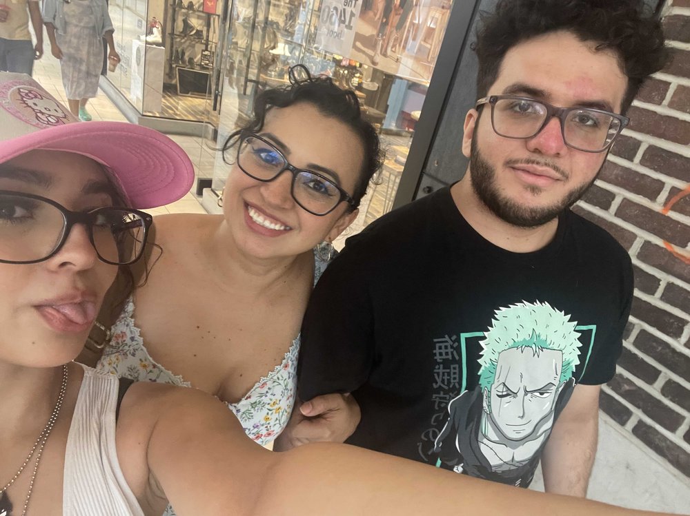 Diana Agudelo poses in an undated selfie flanked by her son and daughter.