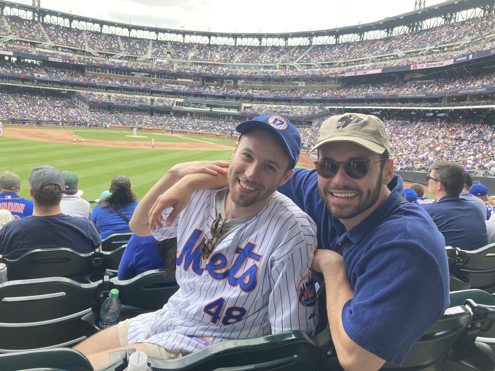 Two fans dressed in Mets uniform.