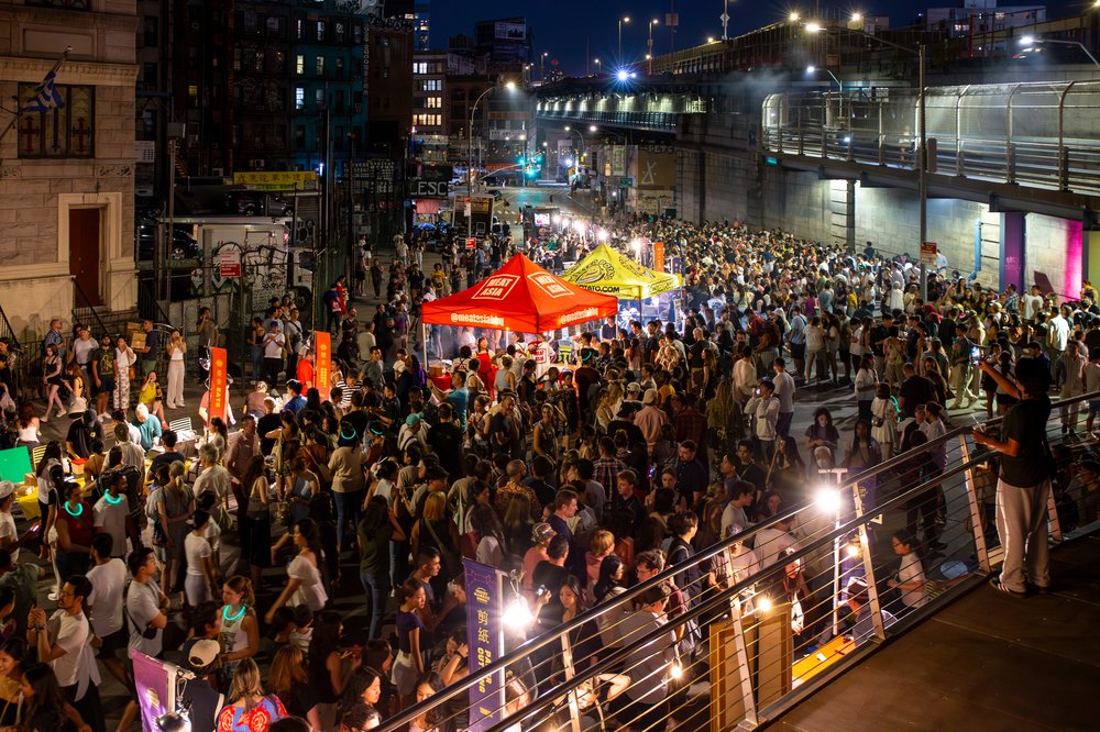 A group of people in a crowded outdoor market.