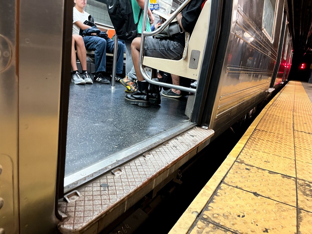 A wide gap between a subway train and platform at the Columbus Circle subway station.