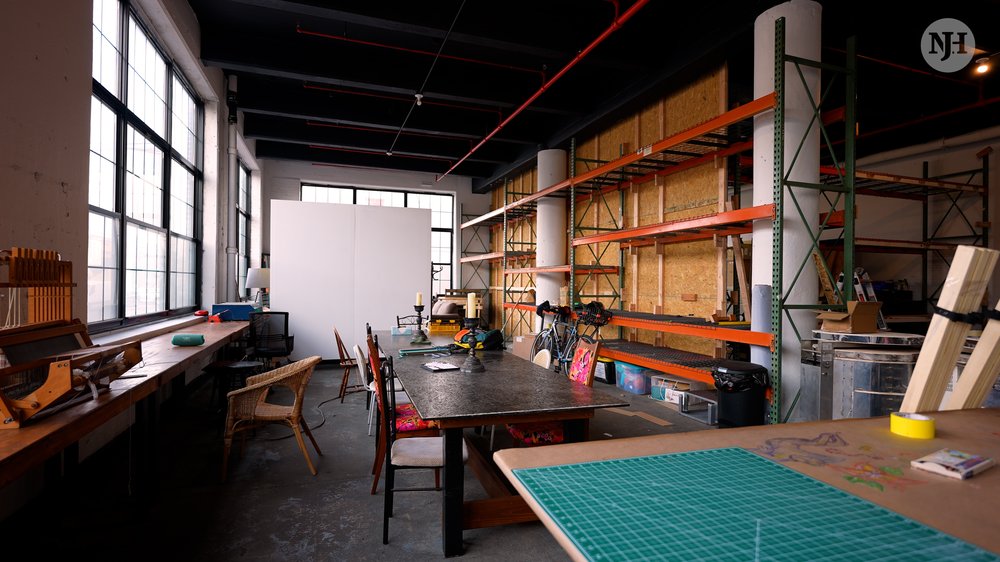 A large room with tables and shelves.