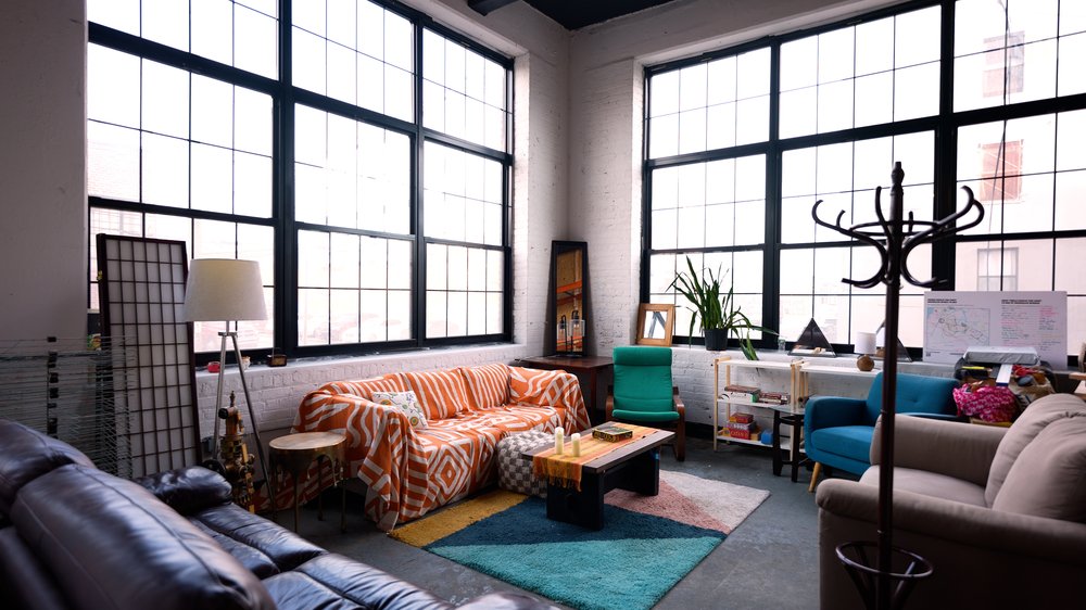 A large room with couches and chairs.