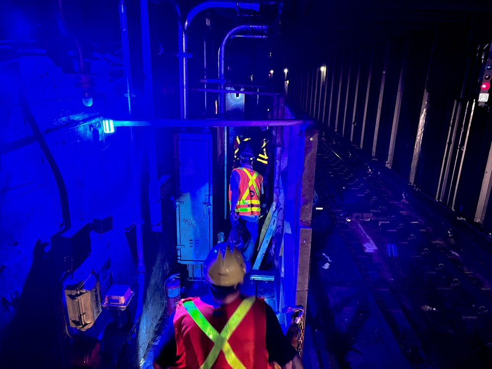 MTA workers inspect signals in the tunnel near the West Fourth Street station on July 31, 2025.