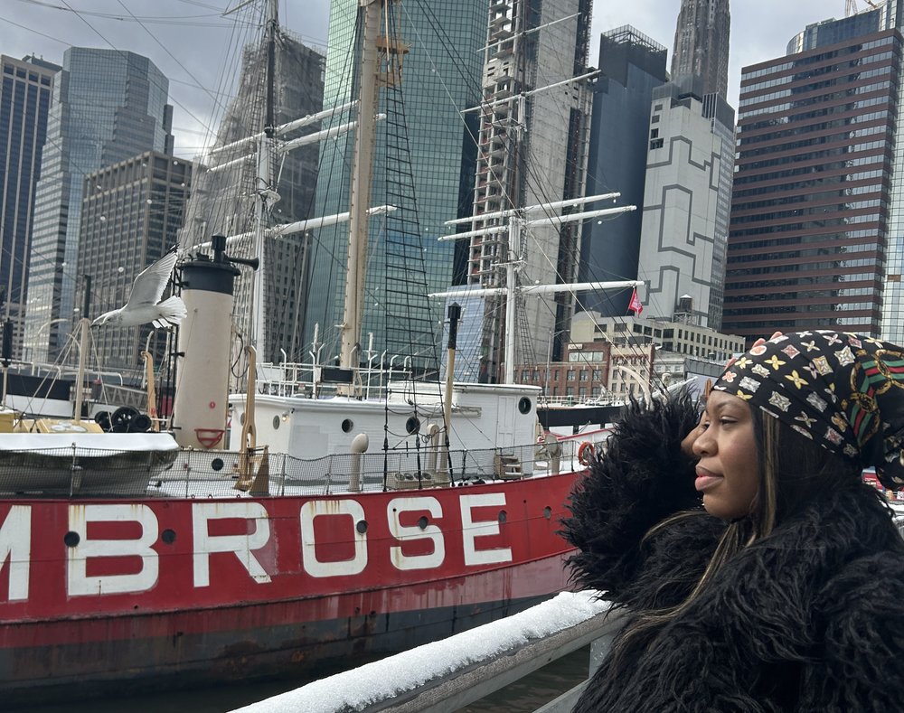 A woman looks at a boat in downtown Manhattan.