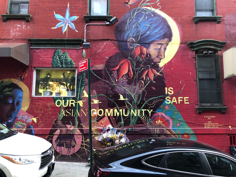 A mural on Mosco Street contains a plea to end anti-Asian hate crime. It also has become a memorial for Christina Yuna Lee, an Asian American woman who was murdered in her nearby apartment.
