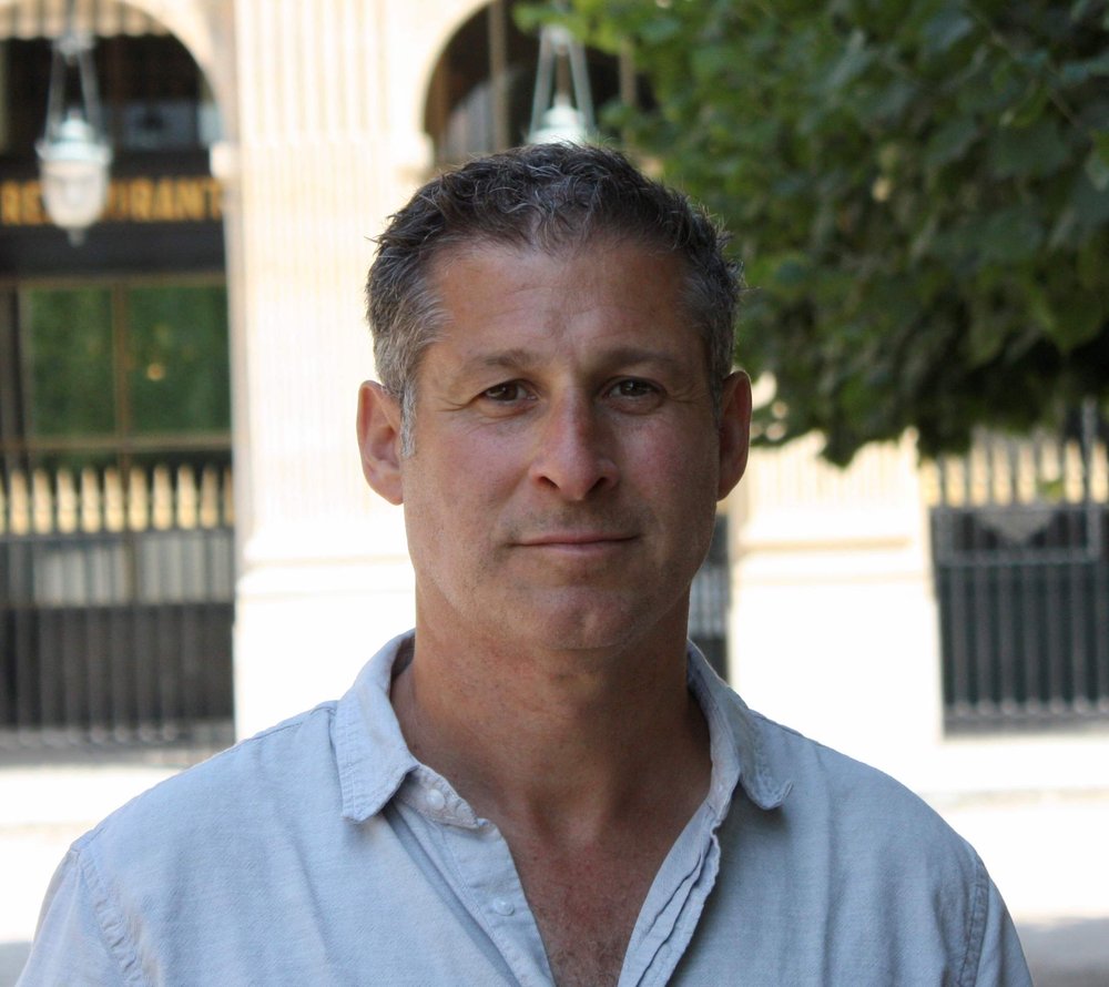 A man photographed outside from his shoulders up.