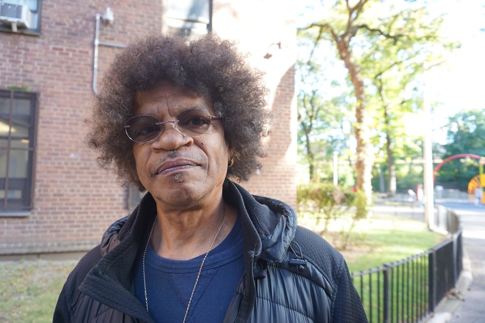 Clinton Turner standing outside the public housing project where he used to live in Flushing, Queens
