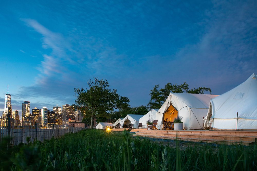 Tents near the New York City skyline.