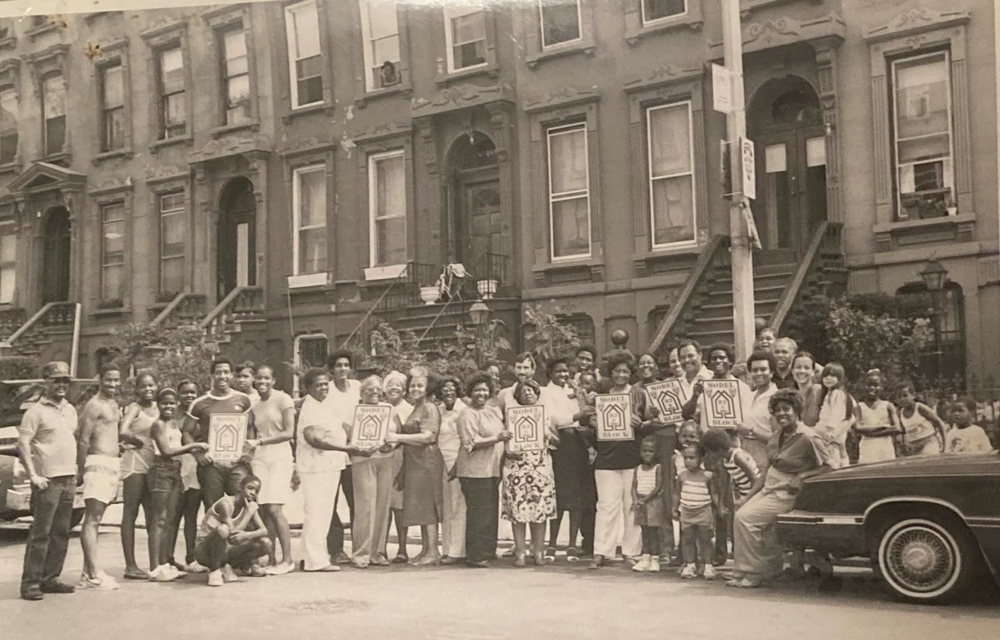 from the collection of Michael Williams. The local block association on Willoughby Avenue between Marcy and Nostrand Aves. posing in the 1970s for a photo to commemorate local renovations as part of the federal Model Cities program.”