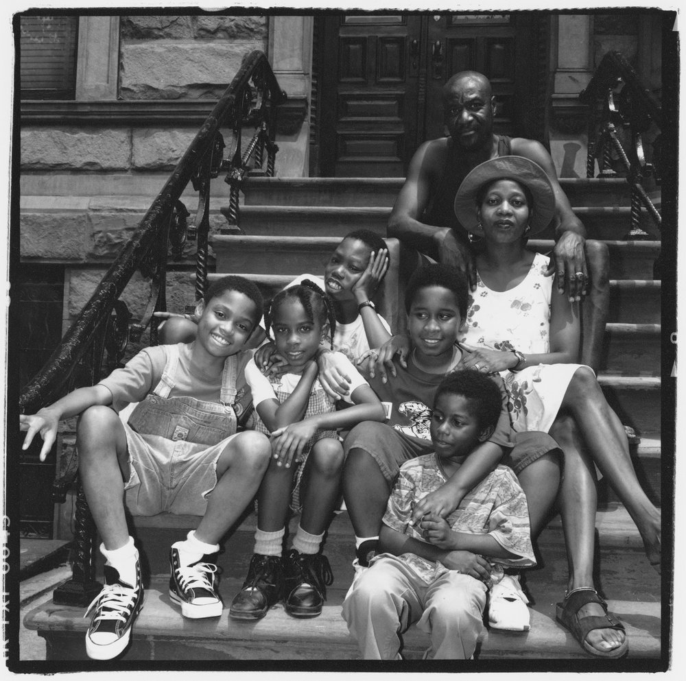 a picture of a family sitting on steps