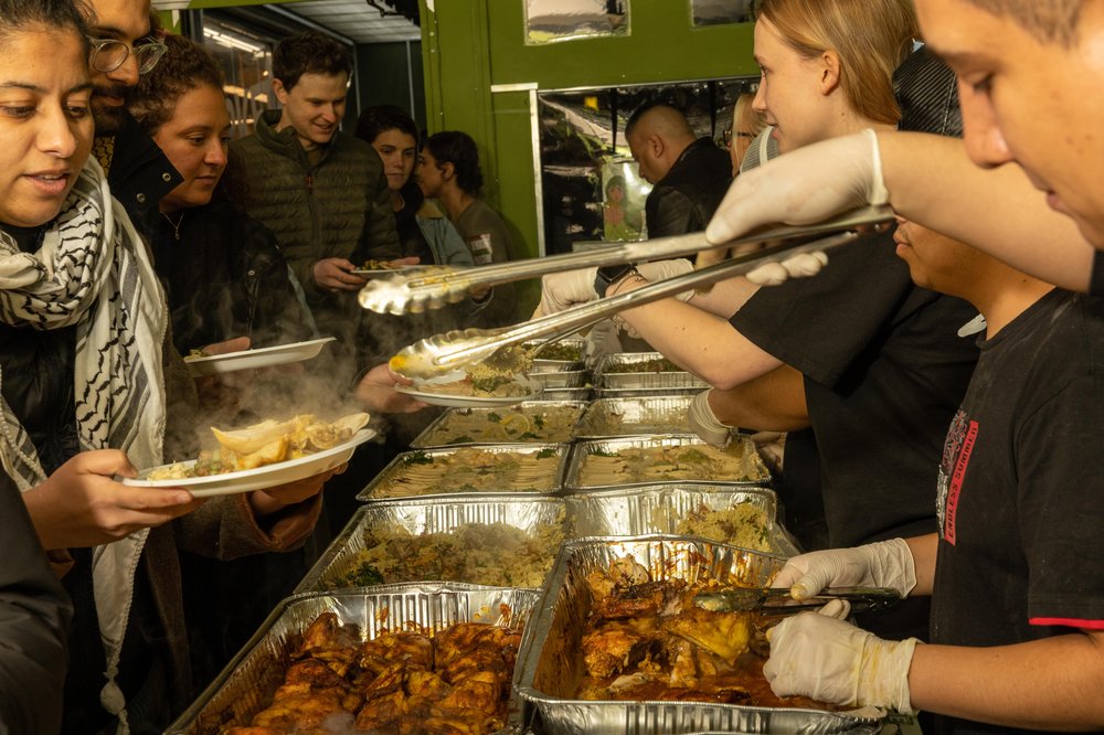 Photo of participants in the Shabbat dinner hosted by the Palestinian-owned restaurant Ayat in the Ditmas Park section of Brooklyn. The event was billed as an opportunity to break "bread" and "barriers" against the backdrop of war in Gaza and spreading violence in the Middle East.