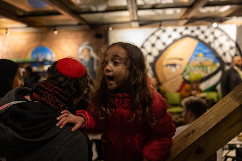 The scene at the Shabbat dinner hosted by the Palestinian-owned restaurant Ayat in the Ditmas Park section of Brooklyn. The event Friday was billed as an opportunity to break "bread" and "barriers" against the backdrop of war in Gaza and spreading violence in the Middle East.