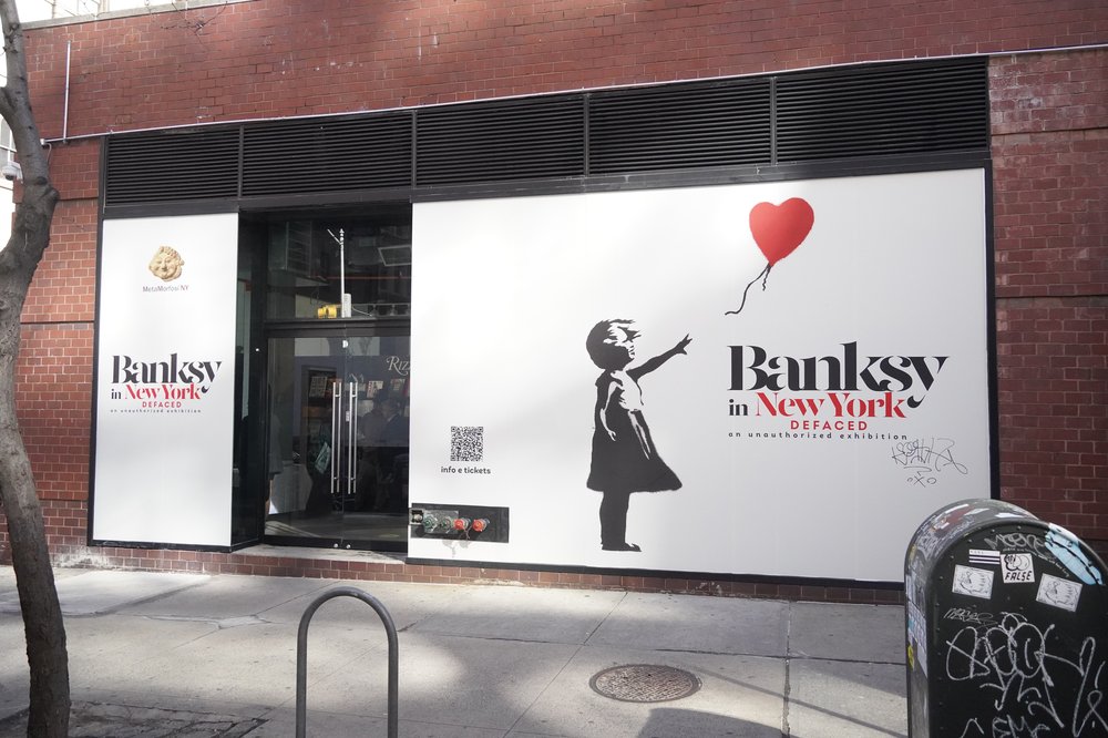 A photo of the outside of the Banksy exhibit