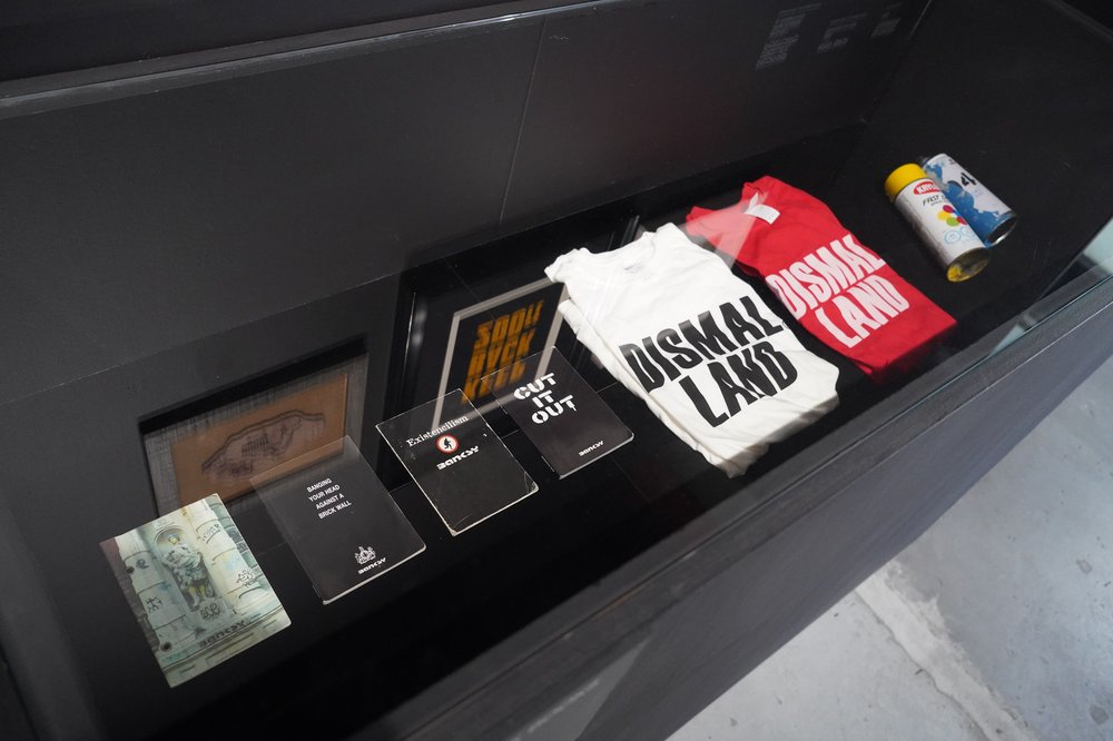 A photo of some of Banksy's earliest black books and t-shirts