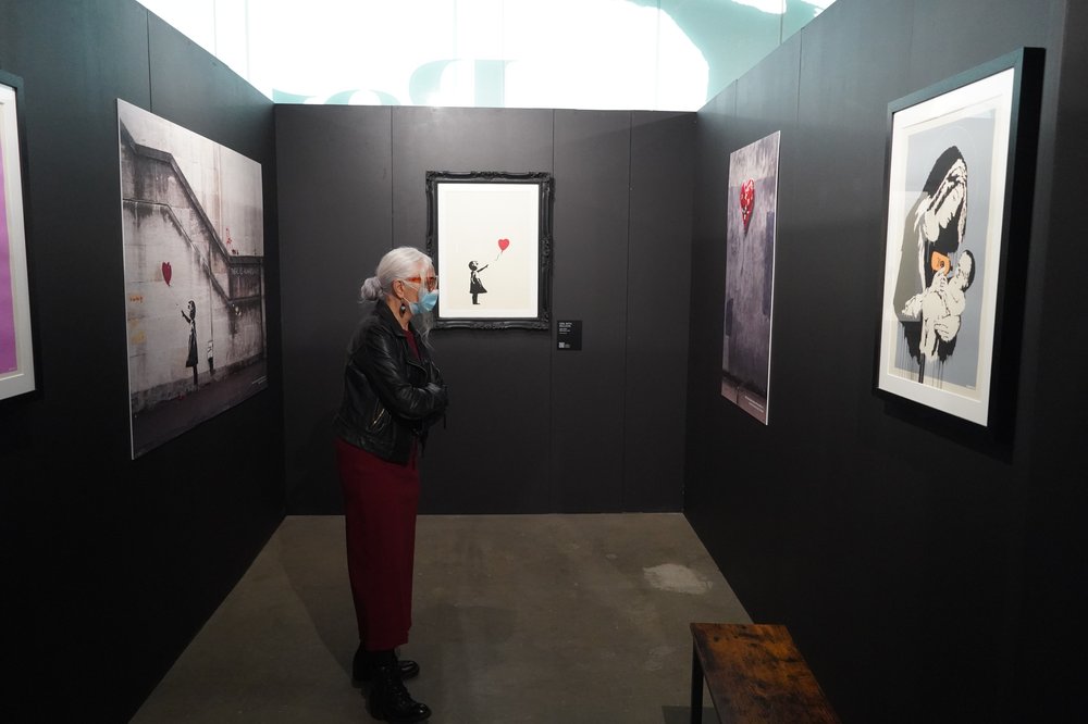 A photo of Elena Frigenti at the Banksy exhibit