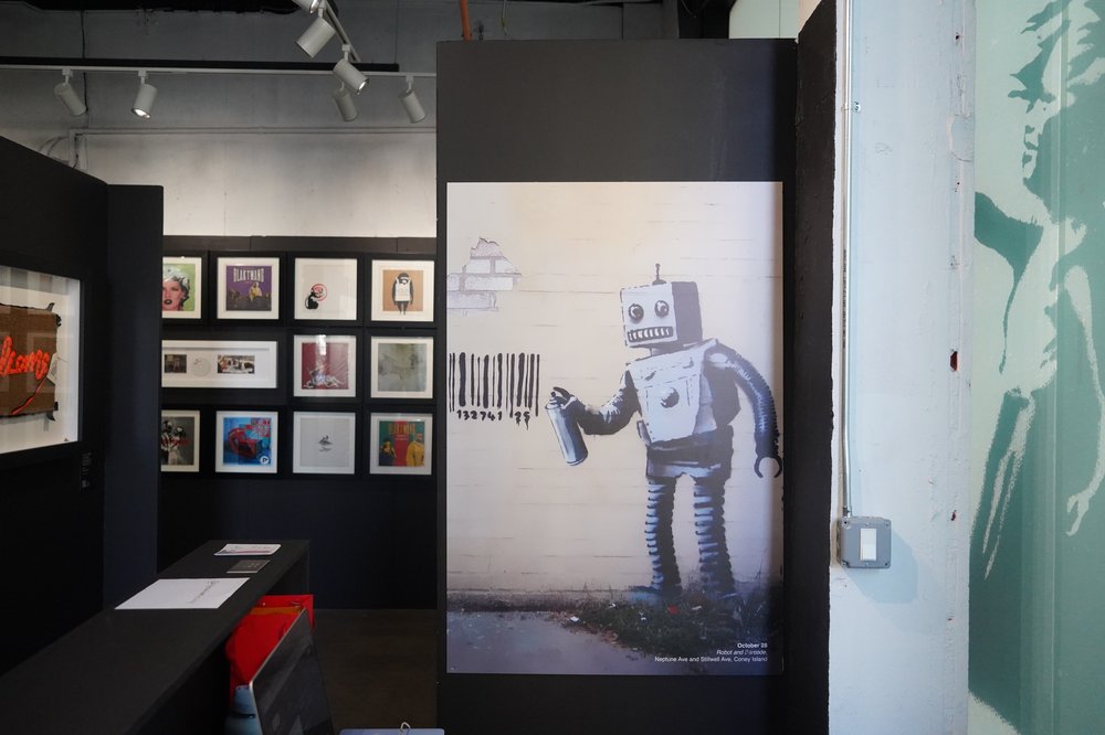 A photo of Banksy's "Robot & Barcode"