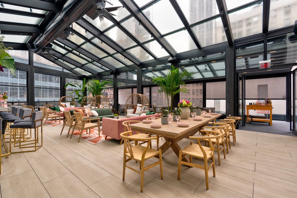 A tidy rooftop bar, with tables and chairs