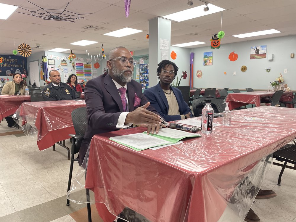 Daniel Henry, director of external affairs at the Mayor’s Office of Asylum Seeker Operations, at a community board meeting in Brooklyn..
