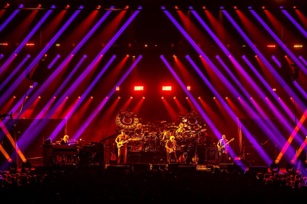 A band playing on a brightly lit stage