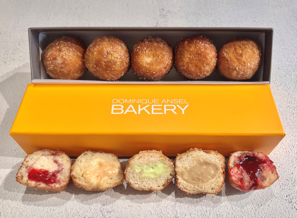 A box of Cronut holes, donut-like pastries filled with cream.