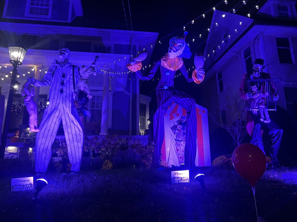 Clowns decorations line a lawn.