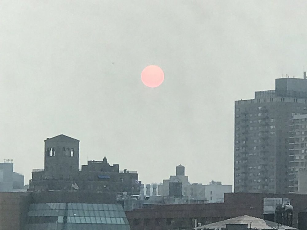A view of the sun as seen in Manhattan on Tuesday morning