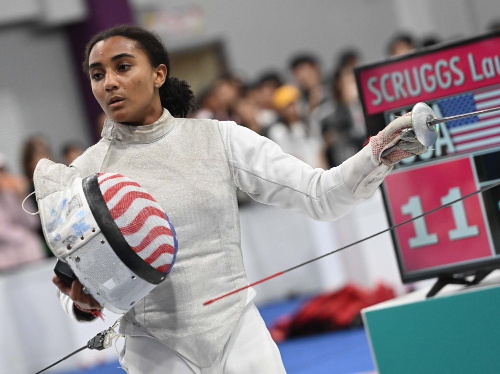 A fencer stands next to a sign that says "11."