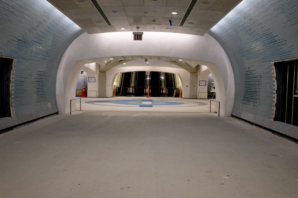 Photograph of the cavernous hall, with escalators at the end