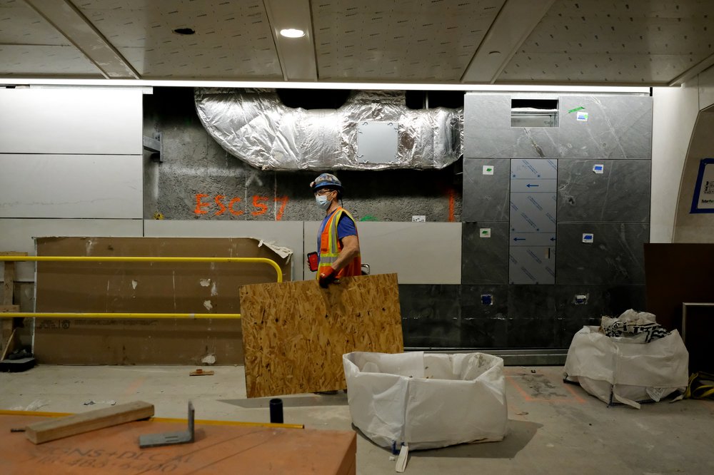 A worker handling some boards on the platform