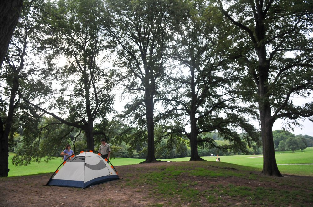 A tent under trees.