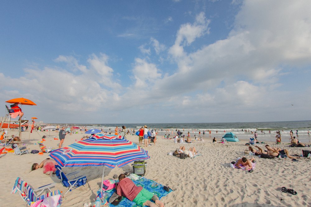 a sandy beach with umbrellas