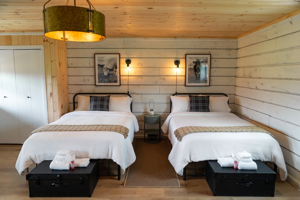 A picture of two beds in a cabin.