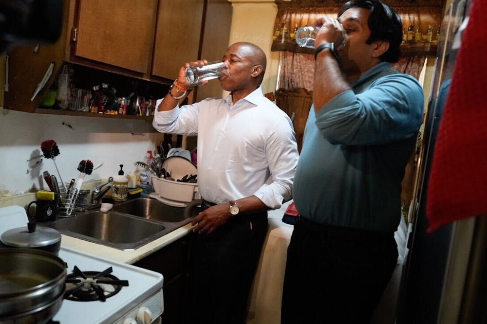 New York City Mayor Eric Adams and Health Commissioner Ashwin Vasan drink tap water from a sink at the Jacob Riis Houses in the East Village. Residents of the public housing complex had been warned not to drink the water due to claims of the water being contaminated with arsenic.