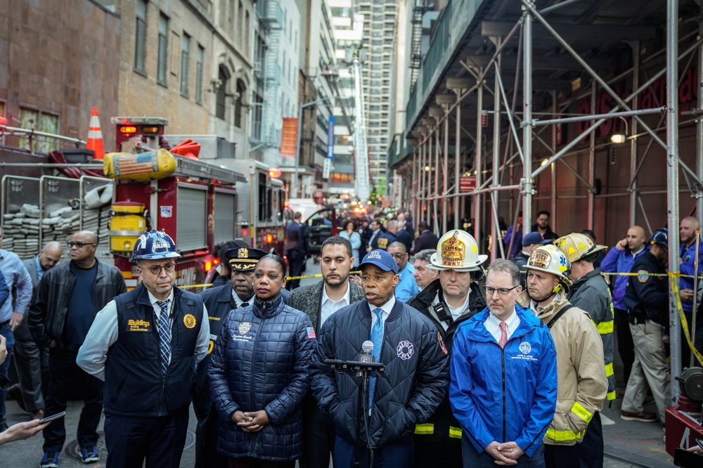 City officials brief the media near the scene of the partial building collapse in Lower Manhattan on Tuesday.