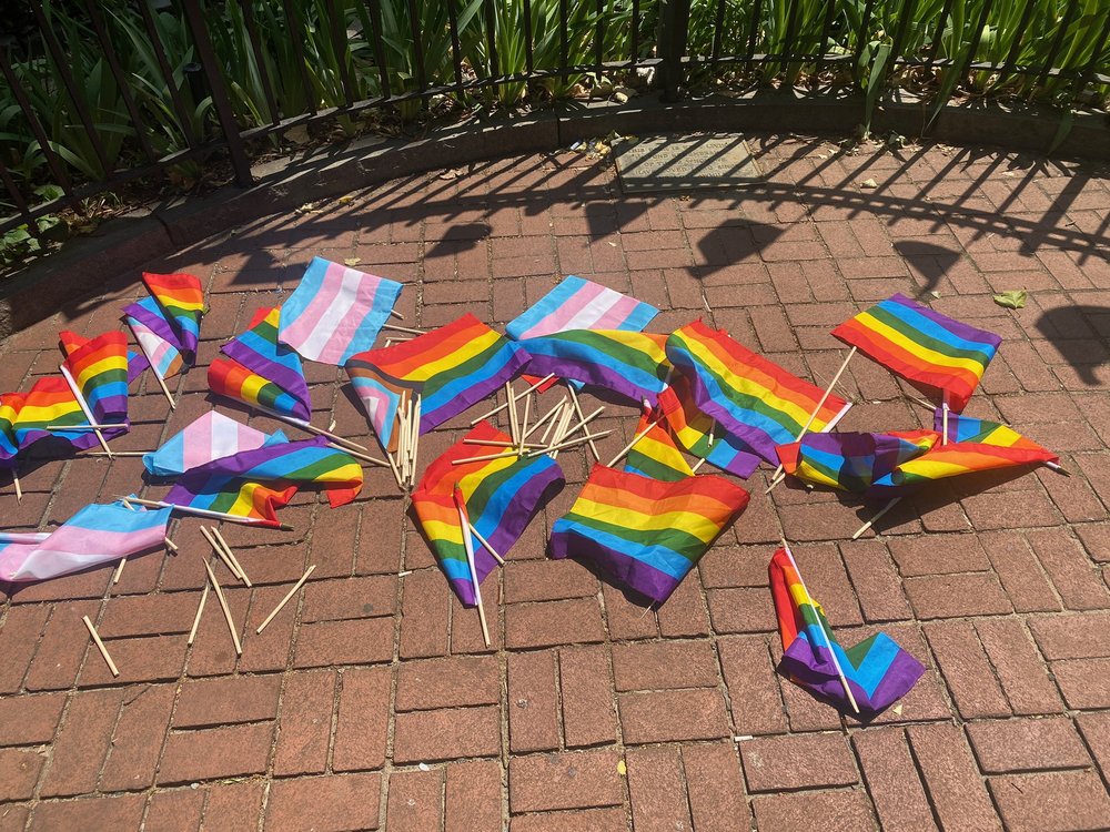 Councilmember Erik Bottcher tweeted this photo of the flags thrown onto the ground near the Stonewall National Monument.