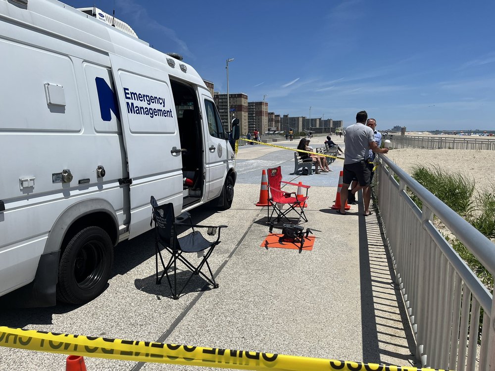 A New York City Office of Emergency Management van next to a drone, which is sitting on the ground.