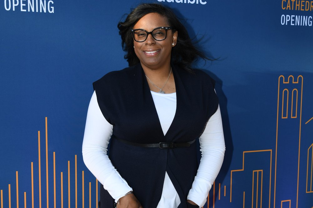Newark Councilwoman LaMonica McIver in front of a backdrop with the Audible logo