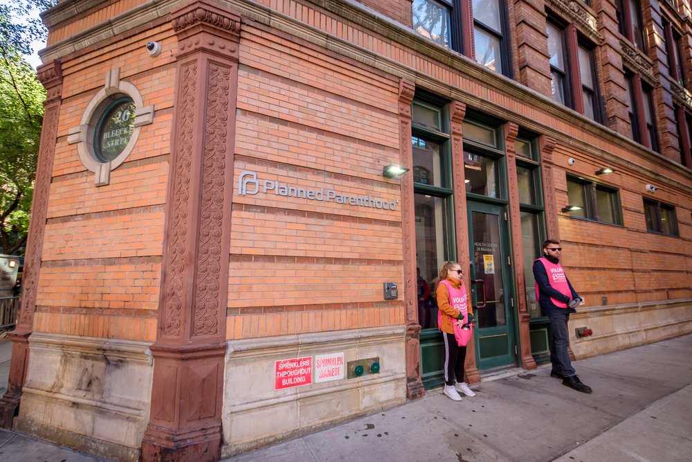 Two volunteers stand at the door of the Planned Parenthood offices in SoHo.