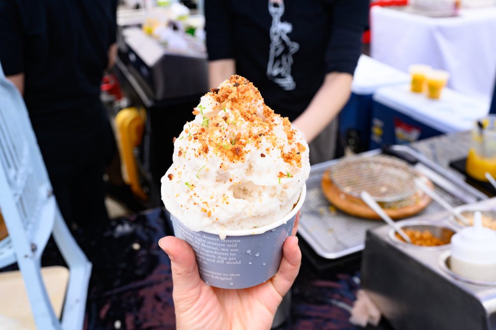 A person holds a shaved ice.