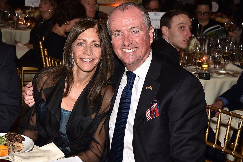 Tammy Murphy and New Jersey Gov. Phil Murphy at a banquet table.