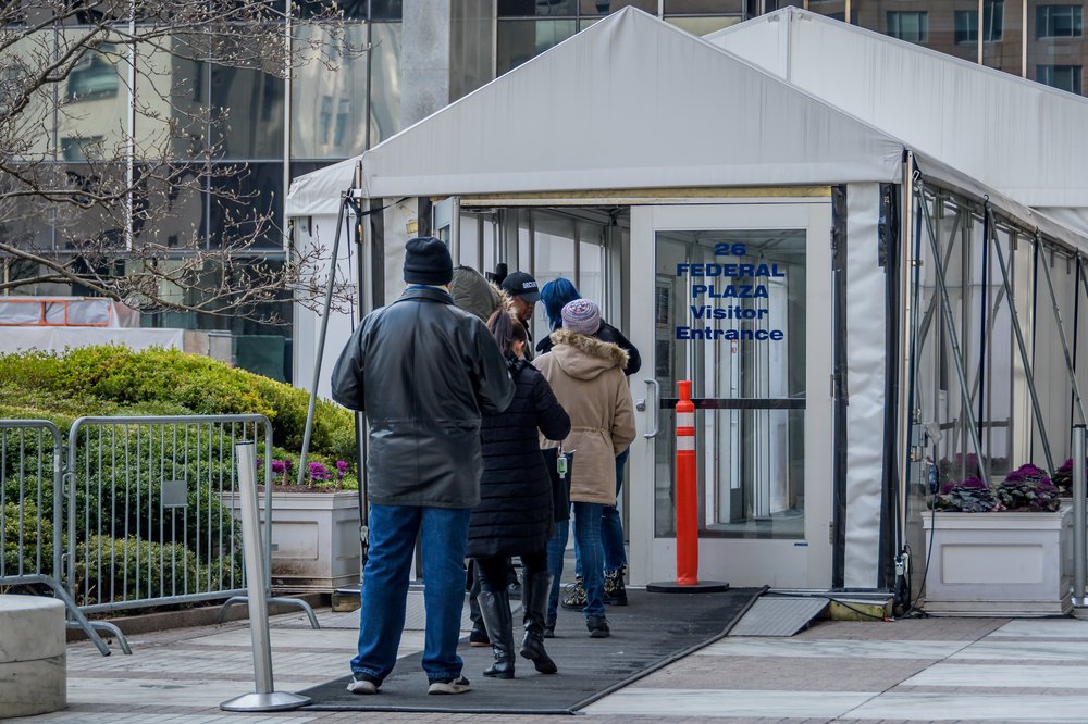A line of people wait to enter 26 Federal Plaza, where the immigration court is.