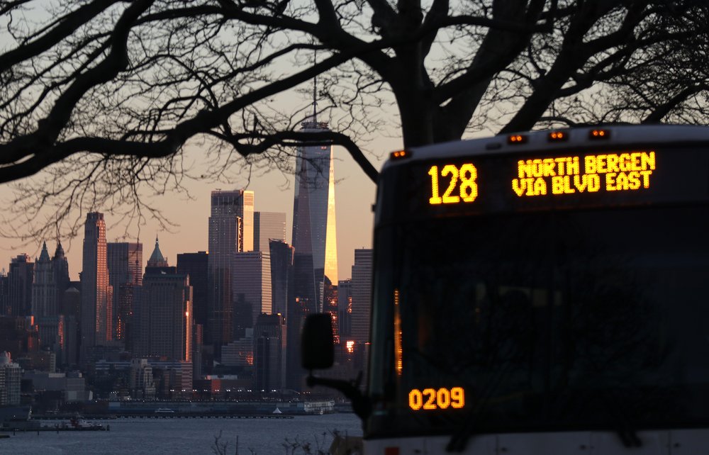 An NJ Transit bus passes by the skyline of lower Manhattan and One World Trade Center in New York City on January 17, 2020 in Weehawken, New Jersey.