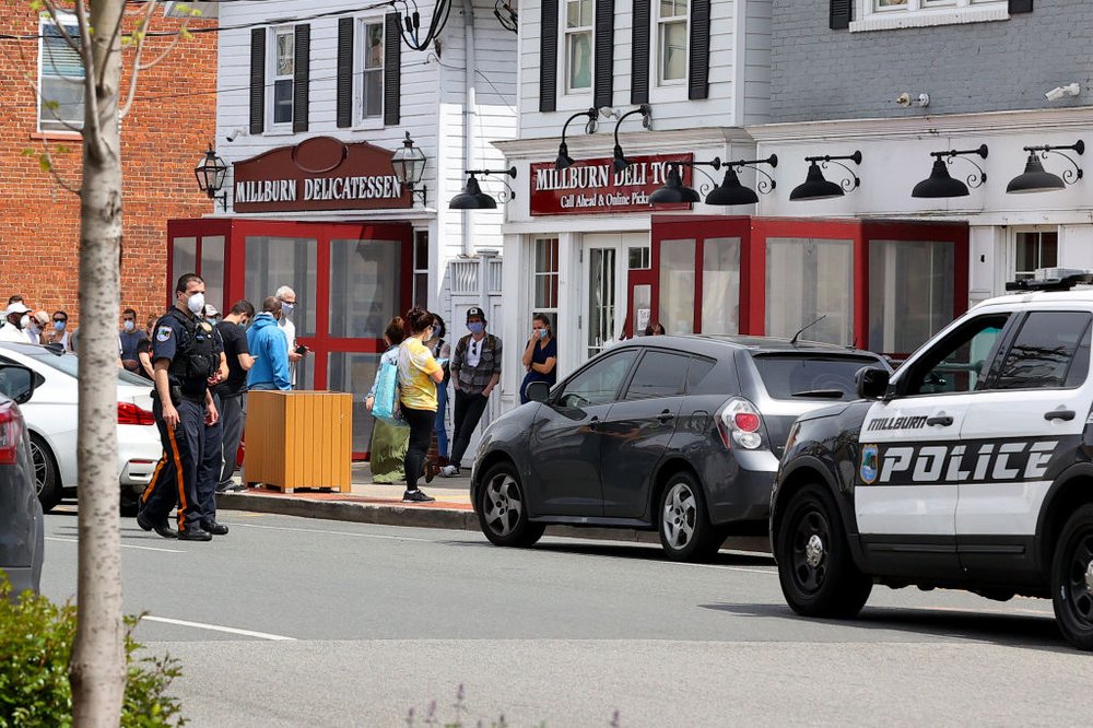 People line up outside of a deli in Millburn.