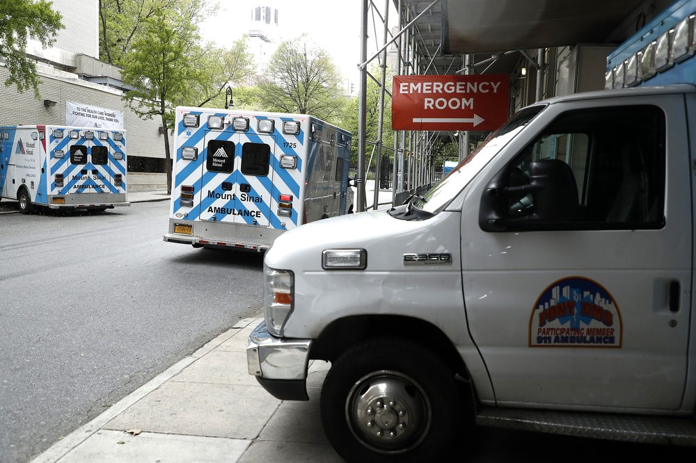 Emergency Medical Technicians move a gurney out of the emergency entrance at Beth Israel hospital in 2020.