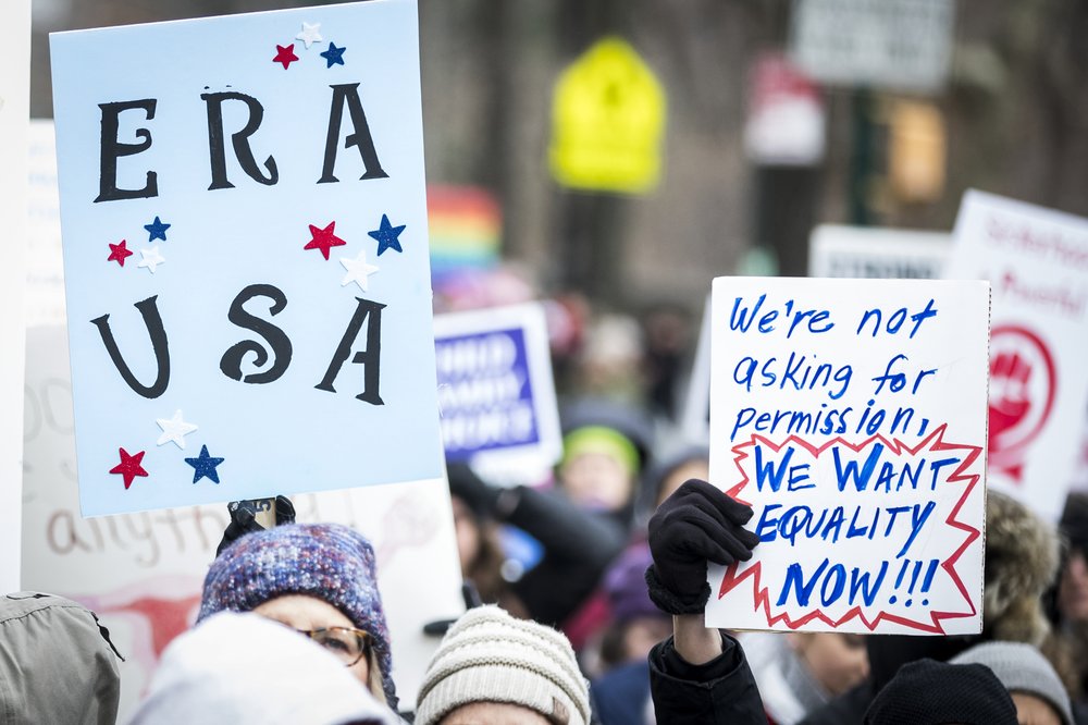 A sign reads "ERA USA" and another says "We're not asking for permission / We want EQUALITY NOW"