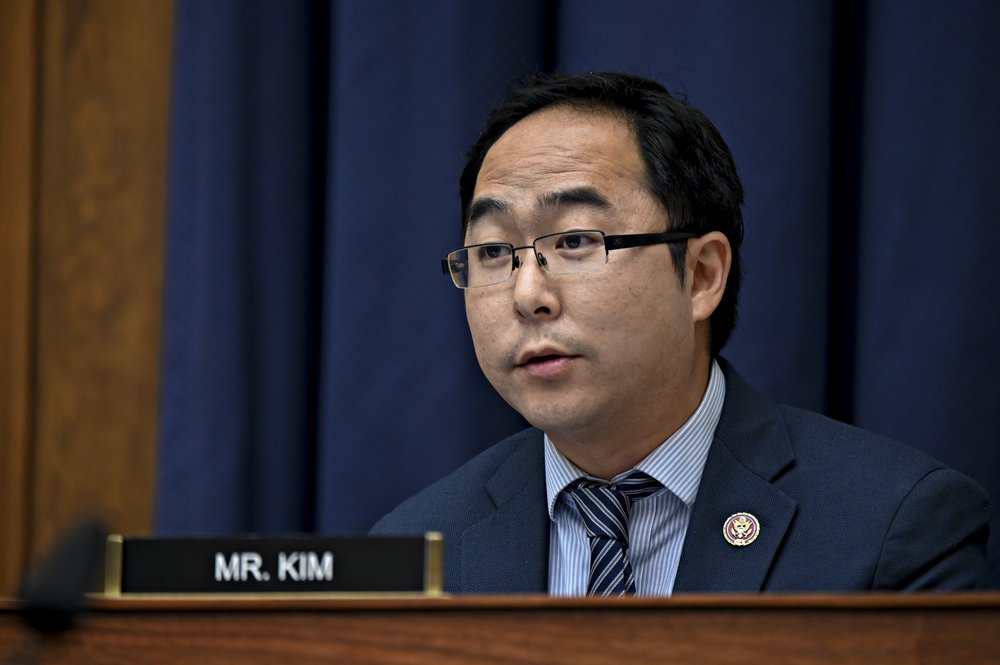 A man speaks at a podium.