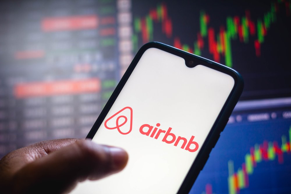 In this photo illustration the Airbnb logo seen displayed on a smartphone screen.