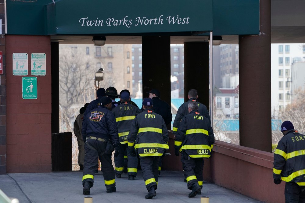 Firefighters walk into the Twin Parks North West apartment building.