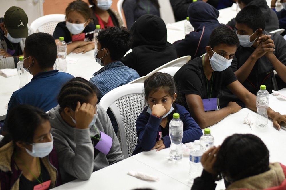 In a May 2022 file photo, unaccompanied migrant minors deported from Mexico wait to eat a meal at a shelter in Quetzaltenango, Guatemala. They were rescued and deported while trying to reach the United States.